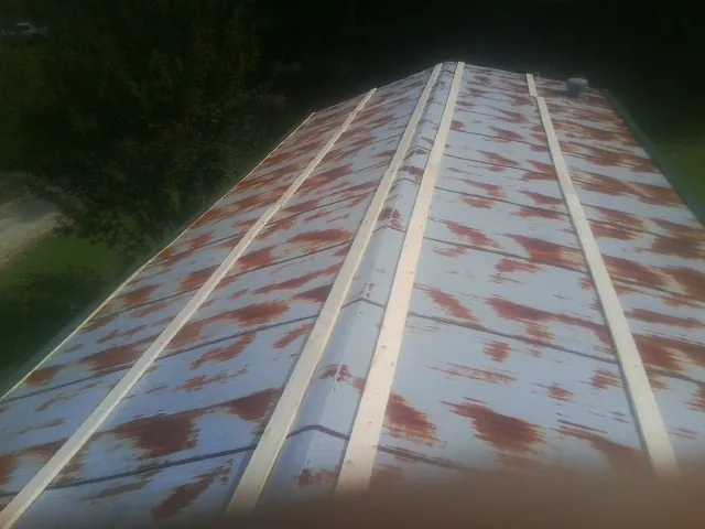 Rusted metal roof panels with new wood purlins before replacement — Storm Damage Roof Repair in Taylor by Roofing Brothers