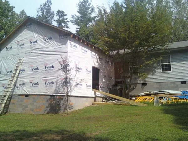 Tyvek wrapped gable on a new room addition beside an existing home in Taylor